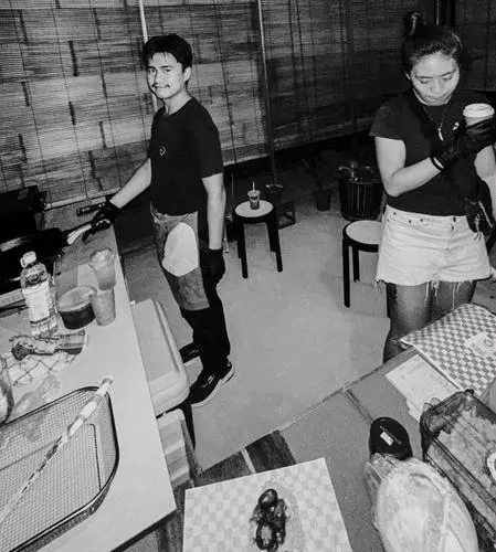 Two people in Byrdhouse shirts working a pop-up griddle in 2019